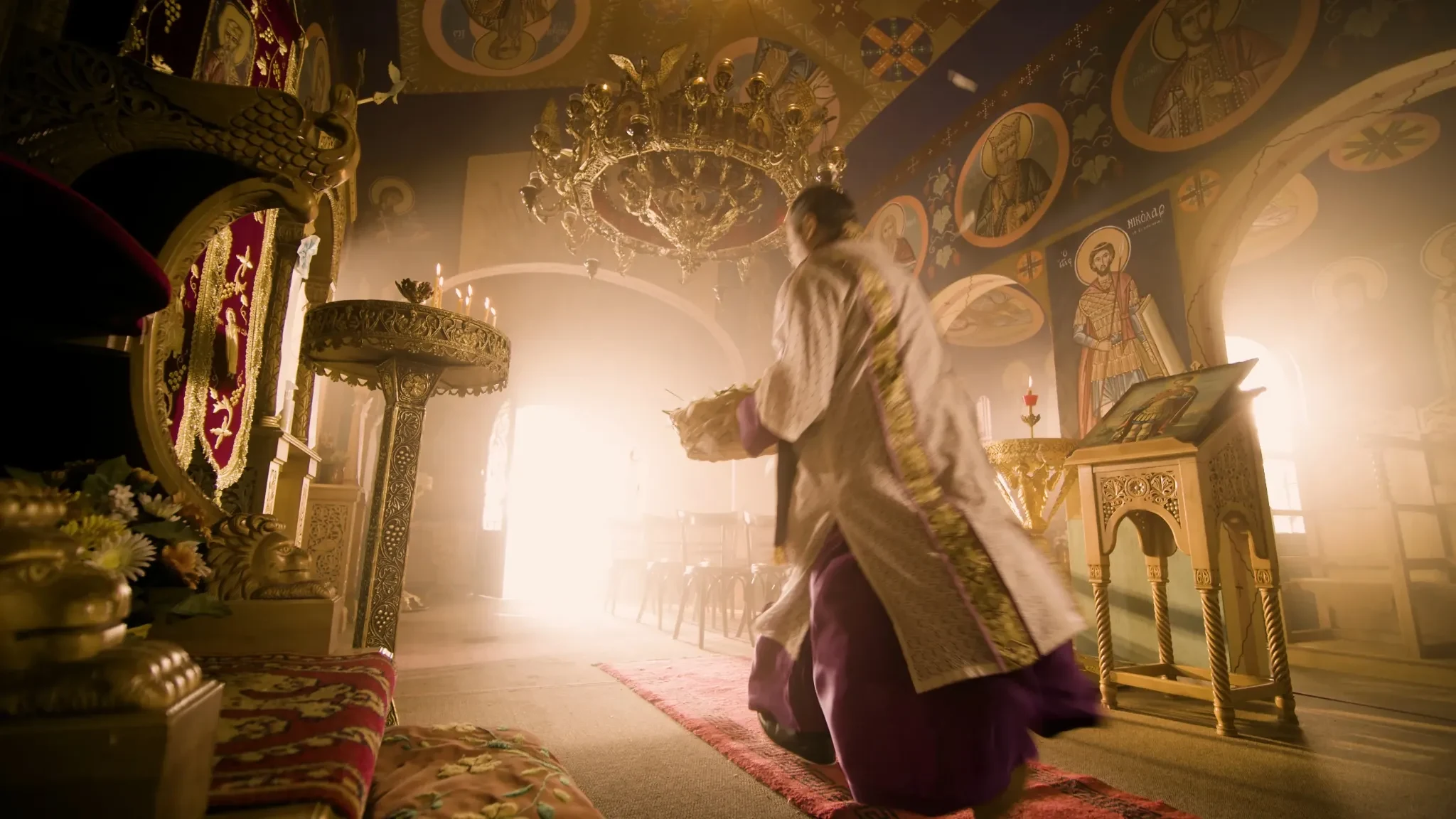 Pyranthemum still of priest dancing ecstatically inside a gold-lit church interior